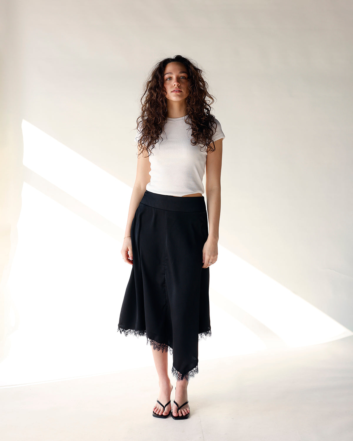 black asymmetrical midi skirt with lace hem detailing women's midi skirt
