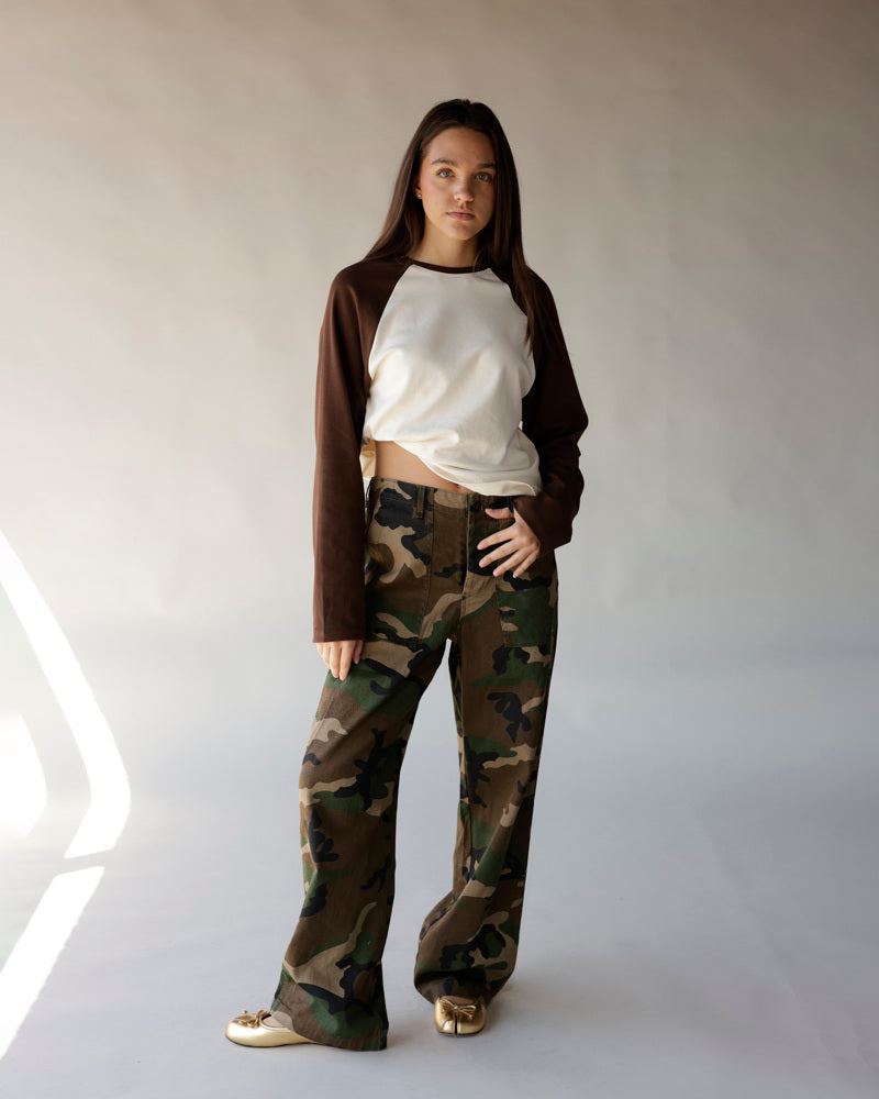 Brown and cream long-sleeve raglan crop top worn with camo wide-leg pants