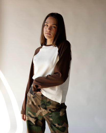 Brown and cream raglan long-sleeve top styled with camo cargo pants