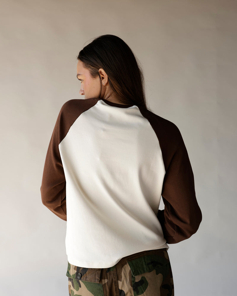 Brown and cream raglan sweatshirt with camo pants, back view
