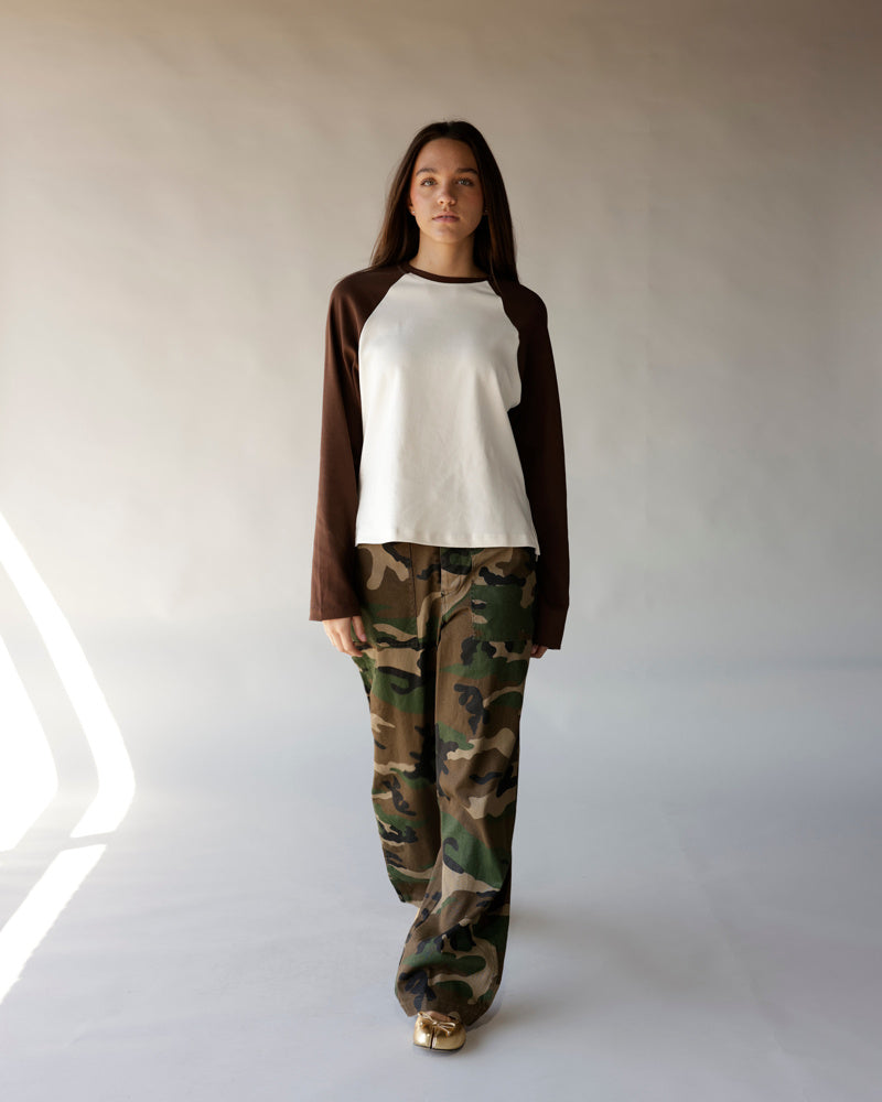Brown and cream long sleeve raglan tee paired with wide-leg camo pants