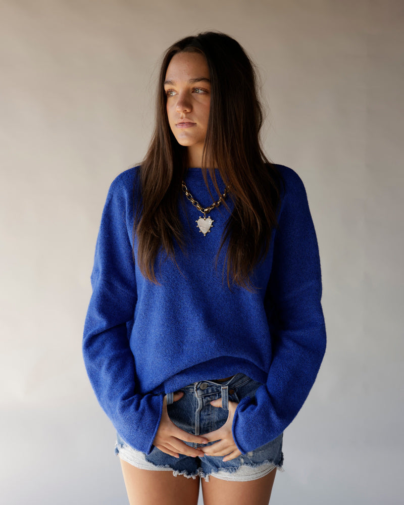 Royal blue cropped mock neck sweater with relaxed fit and textured knit fabric