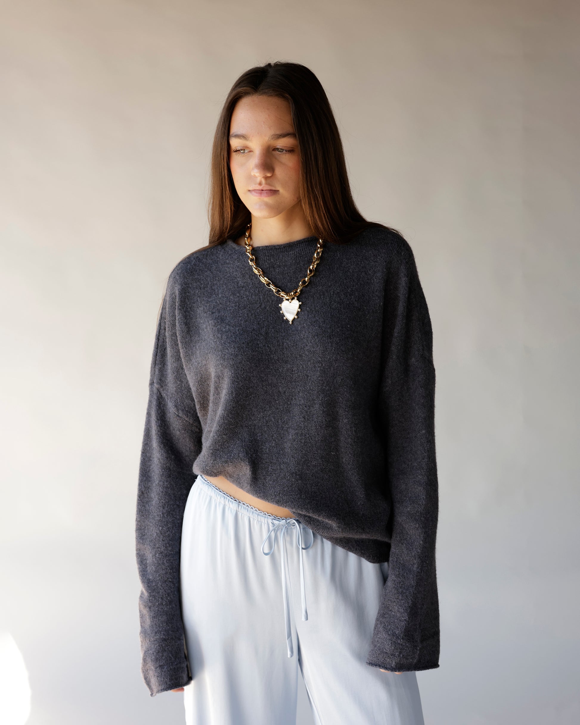 Dark gray cropped mock neck sweater with relaxed fit and dropped shoulders