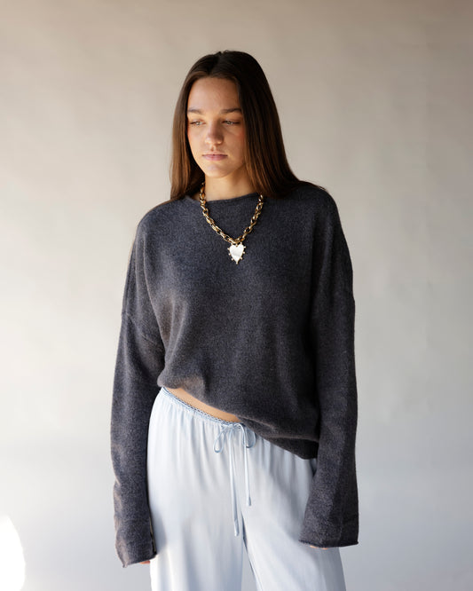 Dark gray cropped mock neck sweater with relaxed fit and dropped shoulders