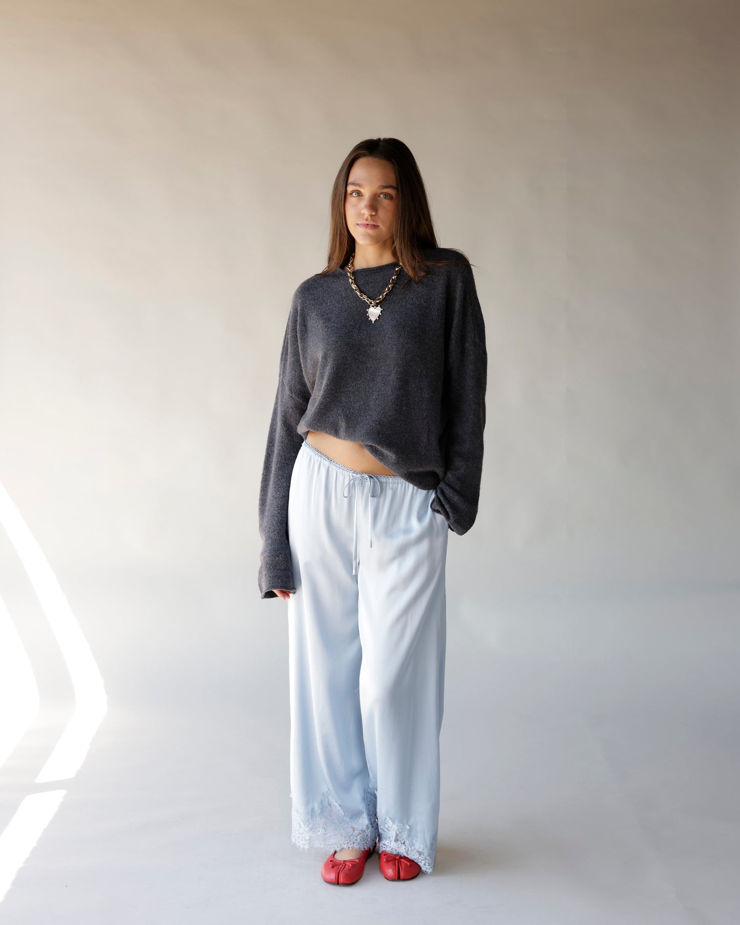Dark gray cropped mock neck sweater with long sleeves, worn casually