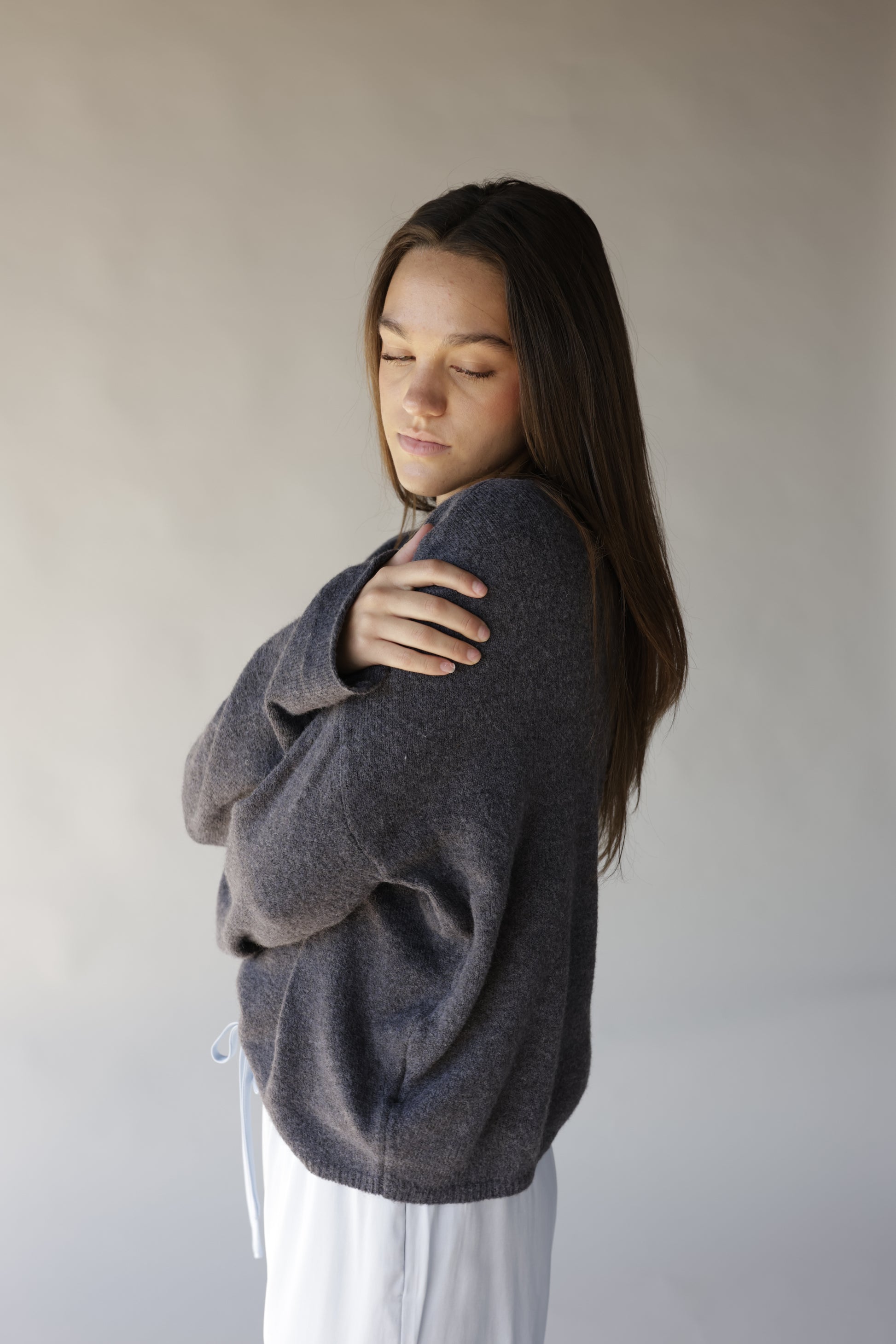 Dark gray mini mock neck sweater with relaxed fit and ribbed hem