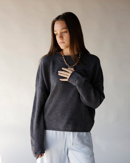 Dark gray oversized knit crew neck sweater with ribbed hem and cuffs