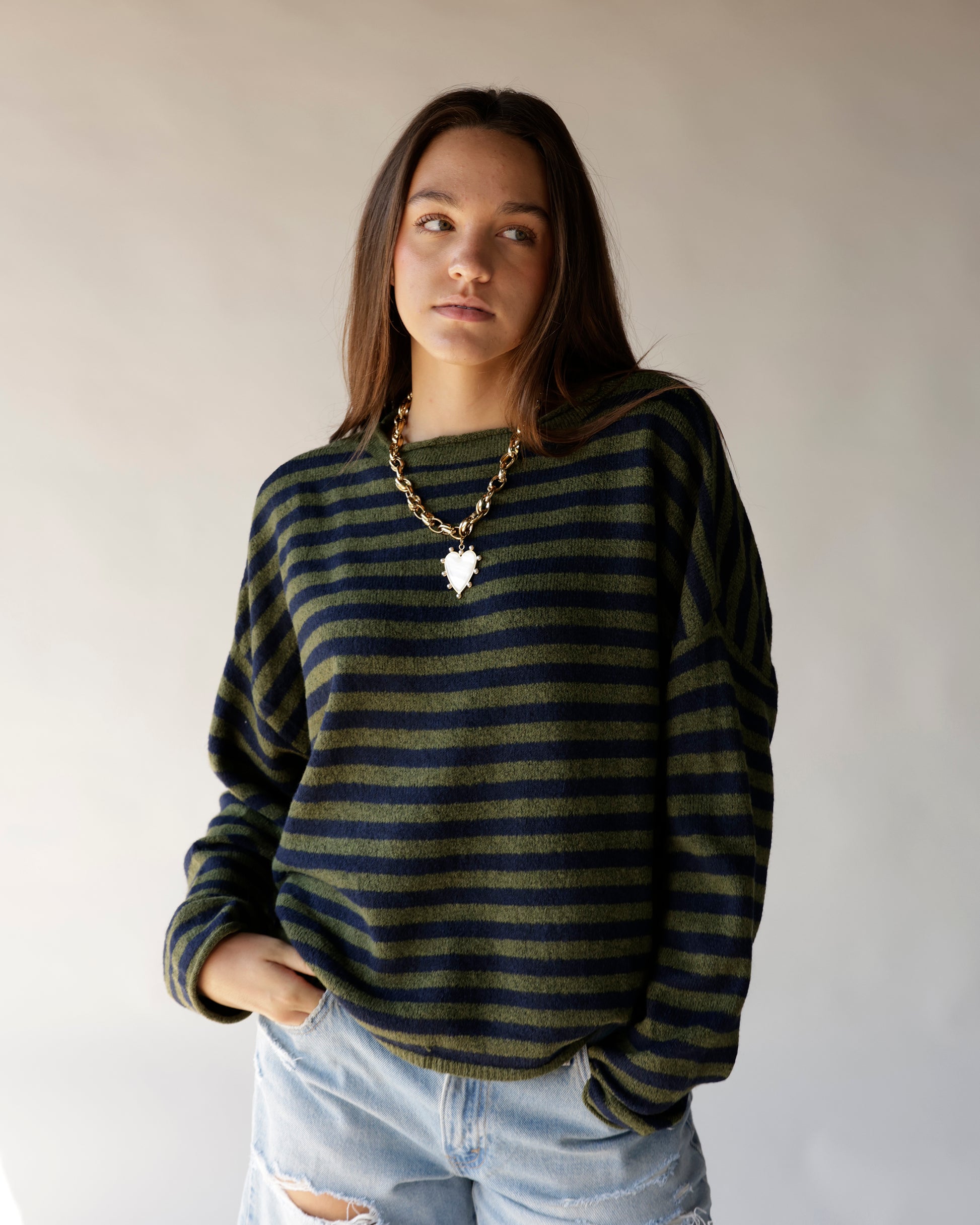 Olive and navy striped mini mock neck sweater with long sleeves on female model