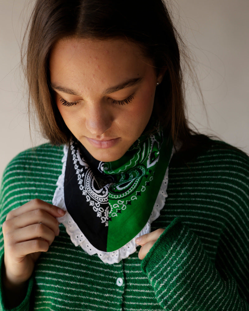 Green and black paisley bandana with white ruffled lace hem worn as neckerchief