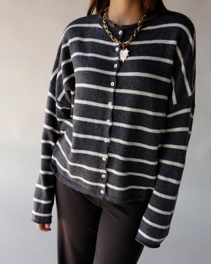Oversized dark grey striped knit cardigan with white buttons and gold chain necklace