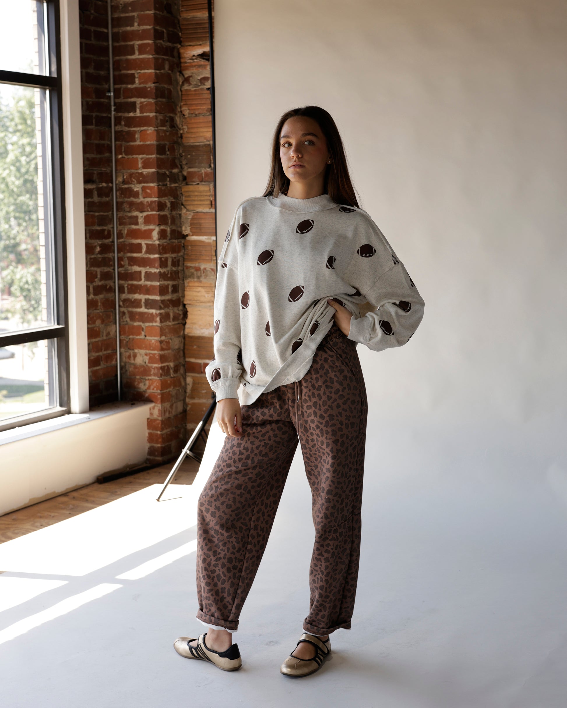 Gray mock neck sweatshirt with allover football print, oversized fit