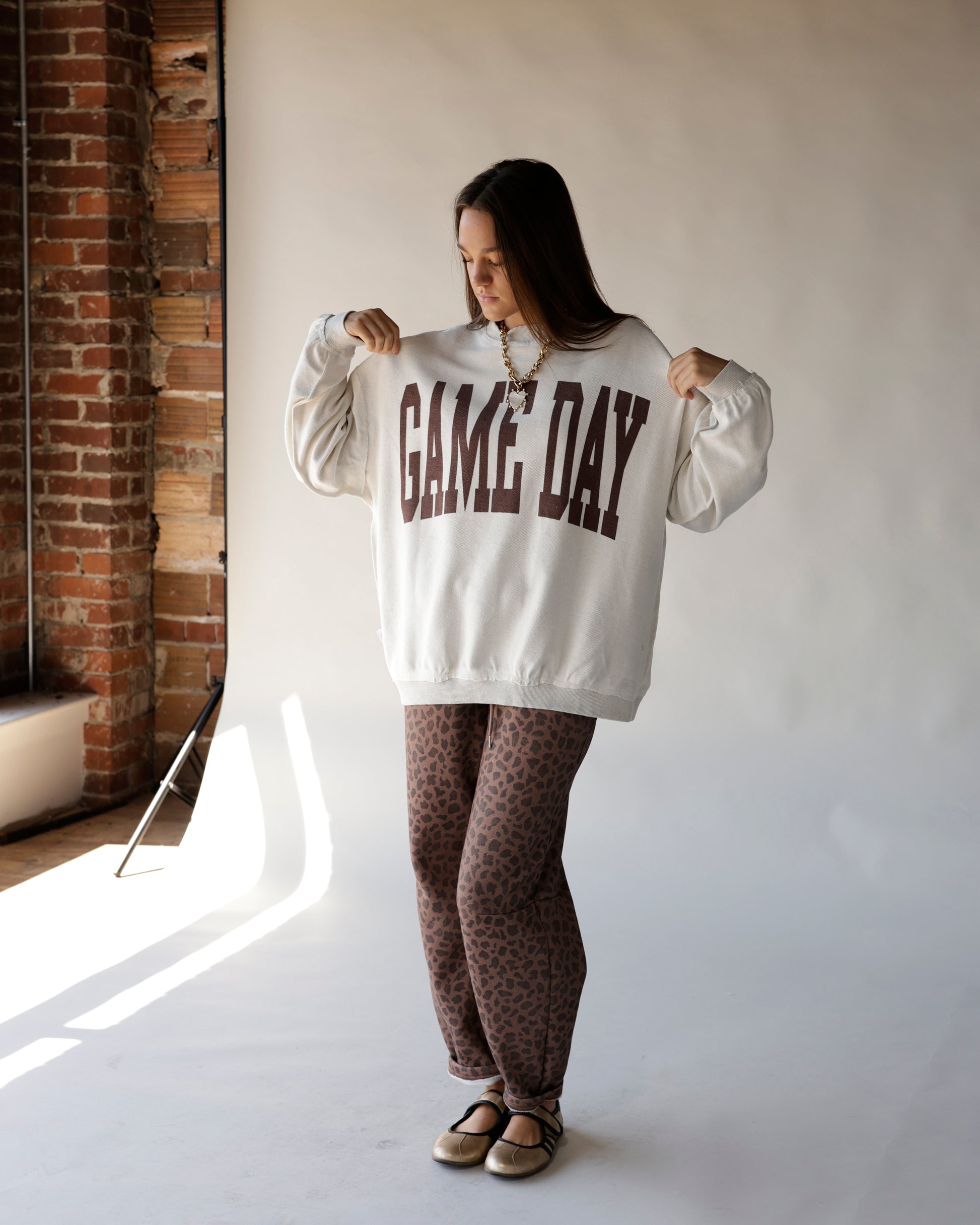 Cream oversized mock neck sweatshirt with brown GAME DAY collegiate graphic print