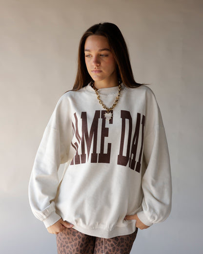 Cream mock neck sweatshirt with brown GAME DAY varsity graphic print on front