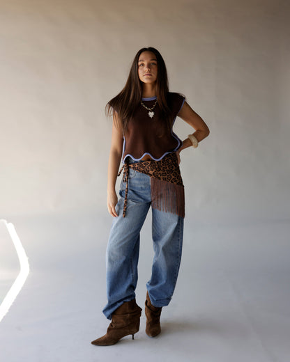Brown sleeveless knit crop top with lavender scallop trim on model with jeans
