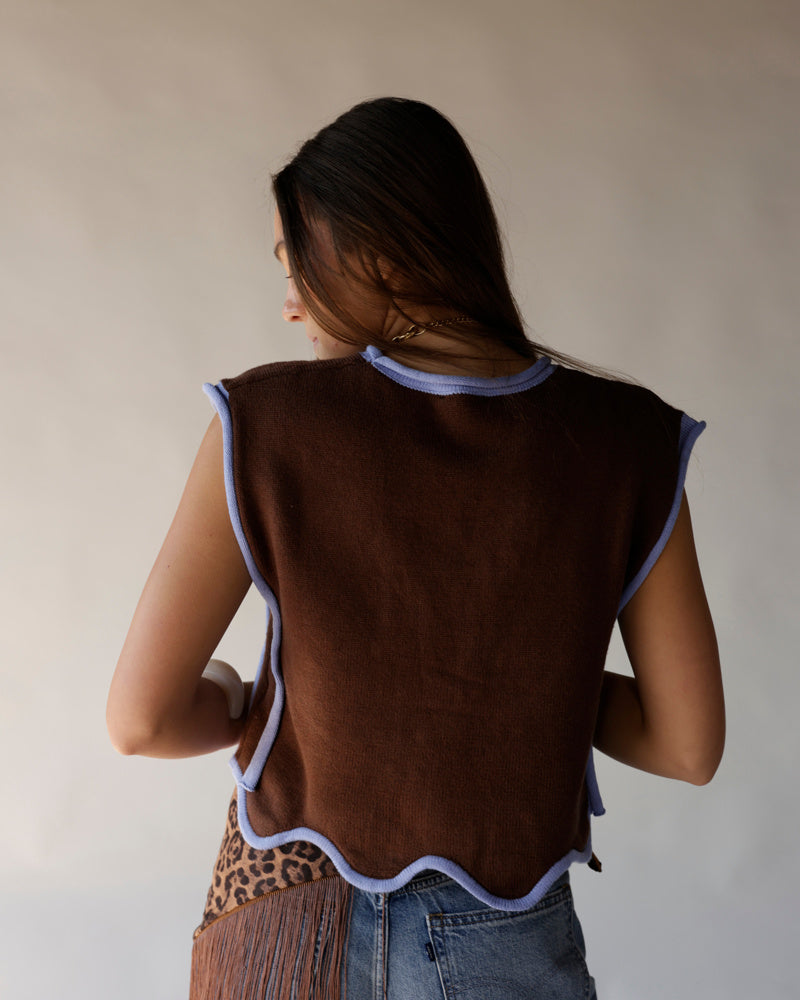 Brown knit cropped vest with lavender scalloped trim, worn with blue jeans