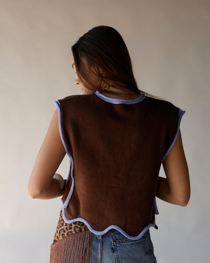 Brown knit cropped vest with lavender scalloped trim, worn with blue jeans