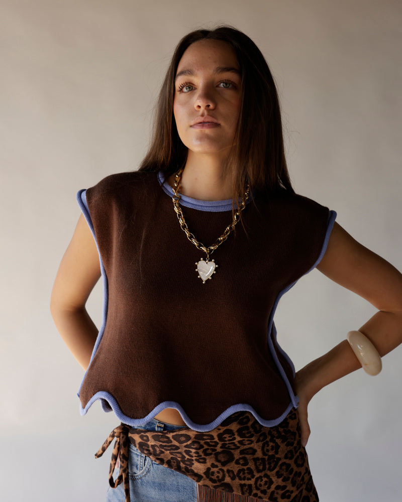 Brown knit crop vest with wavy lavender trim worn over leopard print skirt