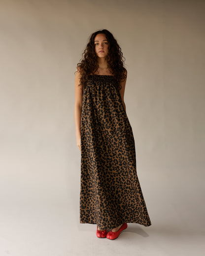 Leopard print strapless maxi dress with smocked bodice, worn with red ballet flats.