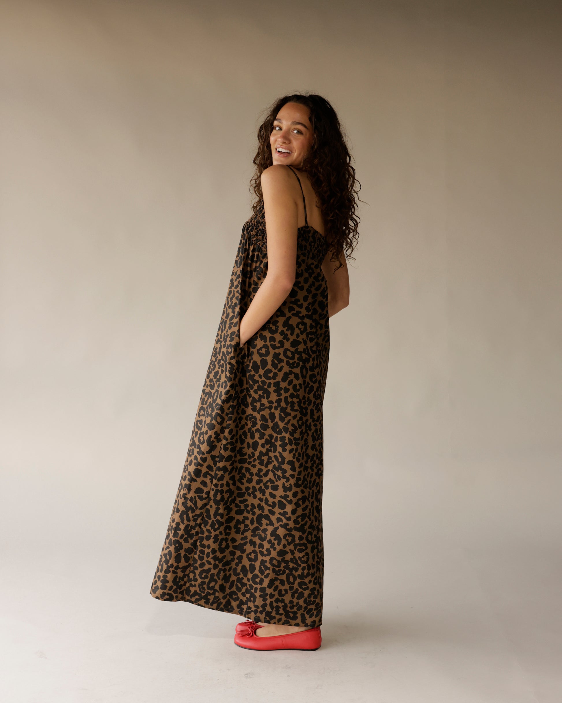 Leopard print maxi dress with thin straps, flowing silhouette, and side pockets