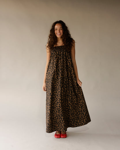 Leopard print sleeveless maxi dress with smocked neckline, worn with red ballet flats