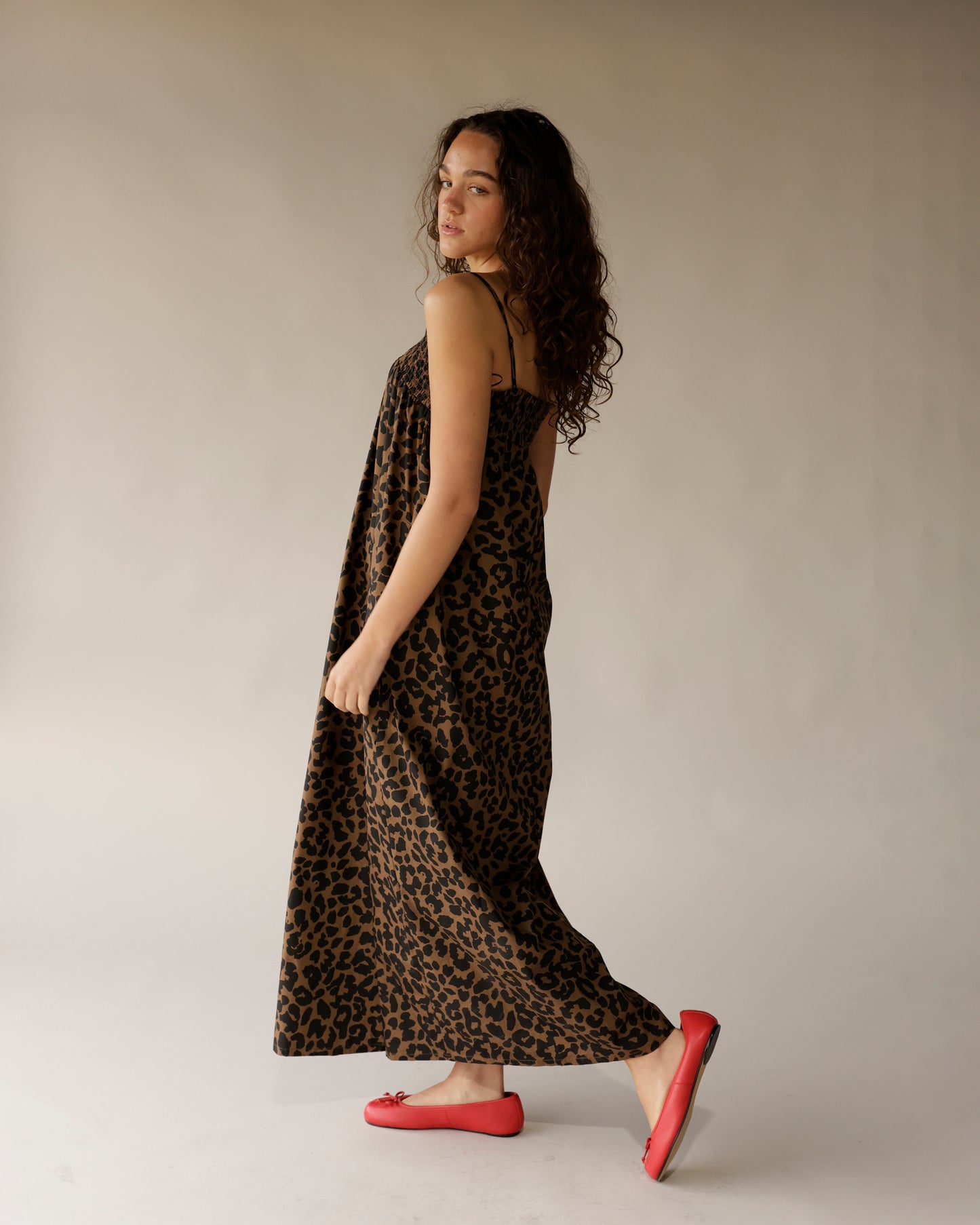 Leopard print brown black maxi dress with thin straps, worn with red ballet flats