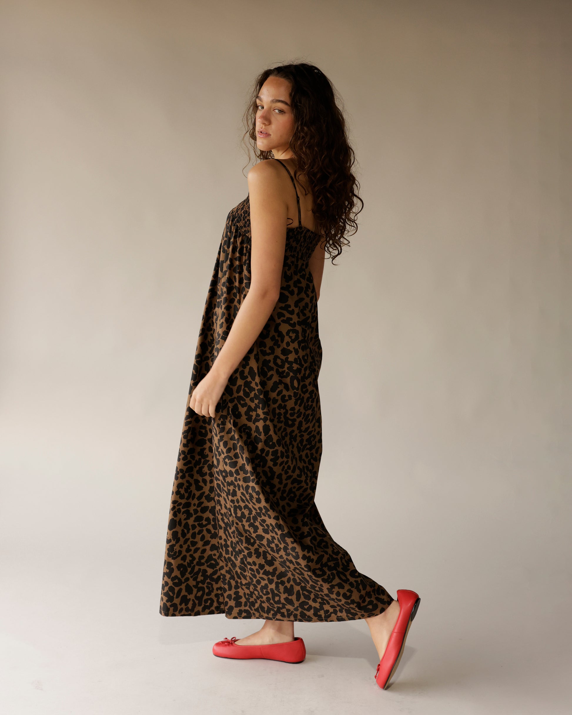 Leopard print brown black maxi dress with thin straps, worn with red ballet flats