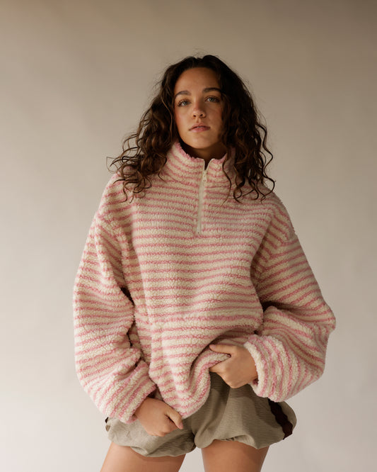 Pink and cream striped sherpa half-zip pullover with oversized fit and quarter zip collar