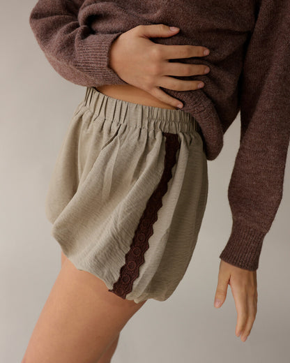 Mocha brown knit sweater styled with sage linen shorts featuring brown lace trim