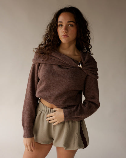 Mocha brown off-shoulder knit sweater with draped neckline and gold clasp detail