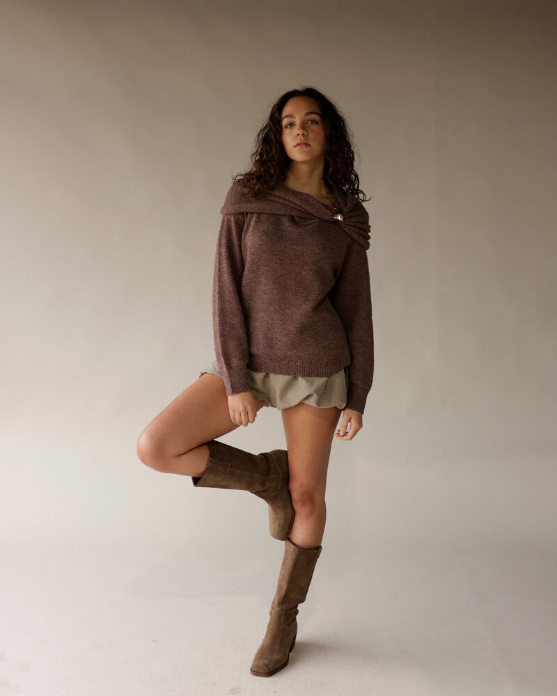 Mocha brown off-shoulder knit sweater with wrap neckline and gold pin detail