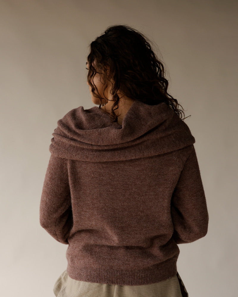 Mocha brown cowl neck knit sweater shown from the back on a model