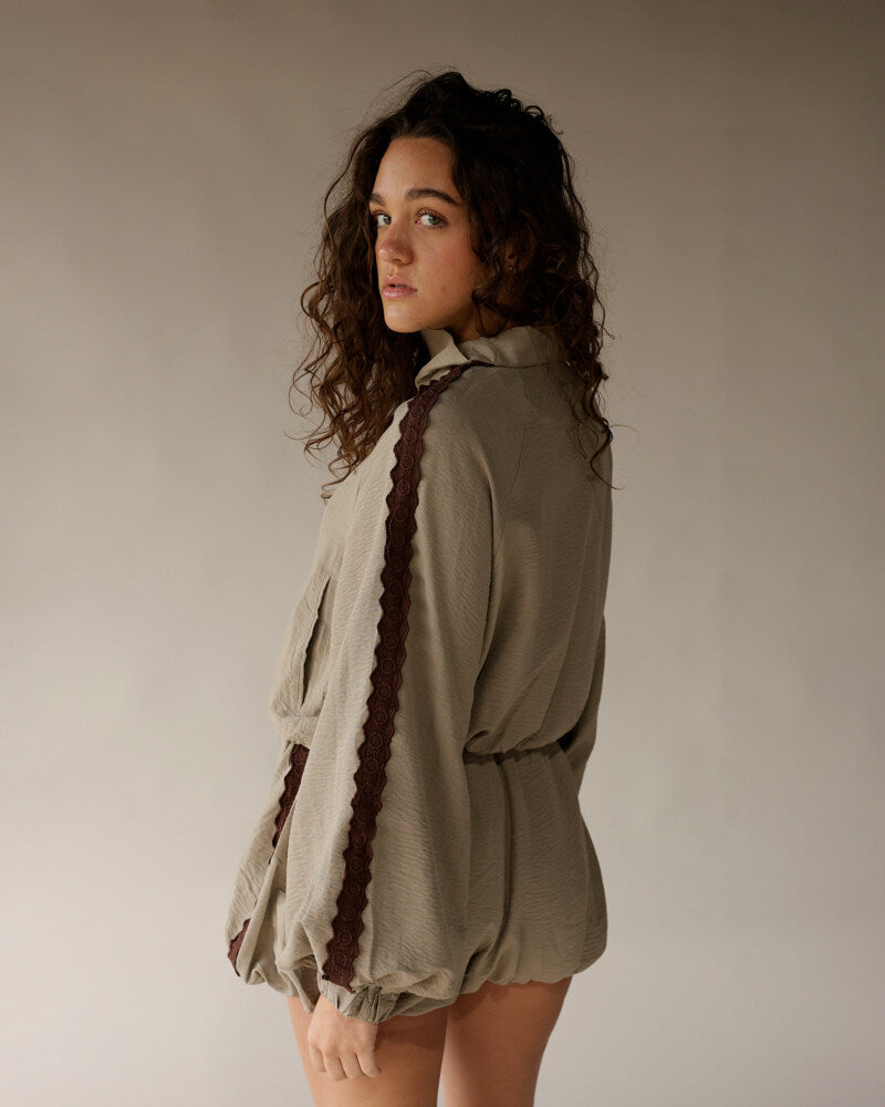 Sage green lace-trim romper with balloon sleeves and brown crochet detail