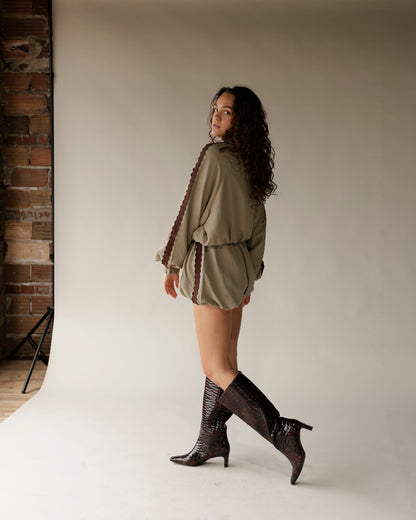 Olive green shorts with brown lace trim detail, worn with croc knee-high boots