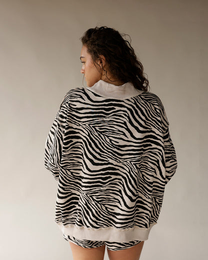 Oversized zebra print mock neck sweatshirt in black and white, back view