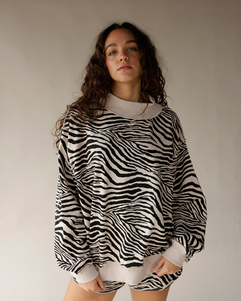 Oversized zebra print reversible mock neck sweatshirt in black and cream