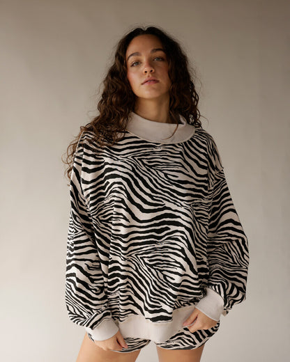 Oversized zebra print reversible mock neck sweatshirt in black and cream