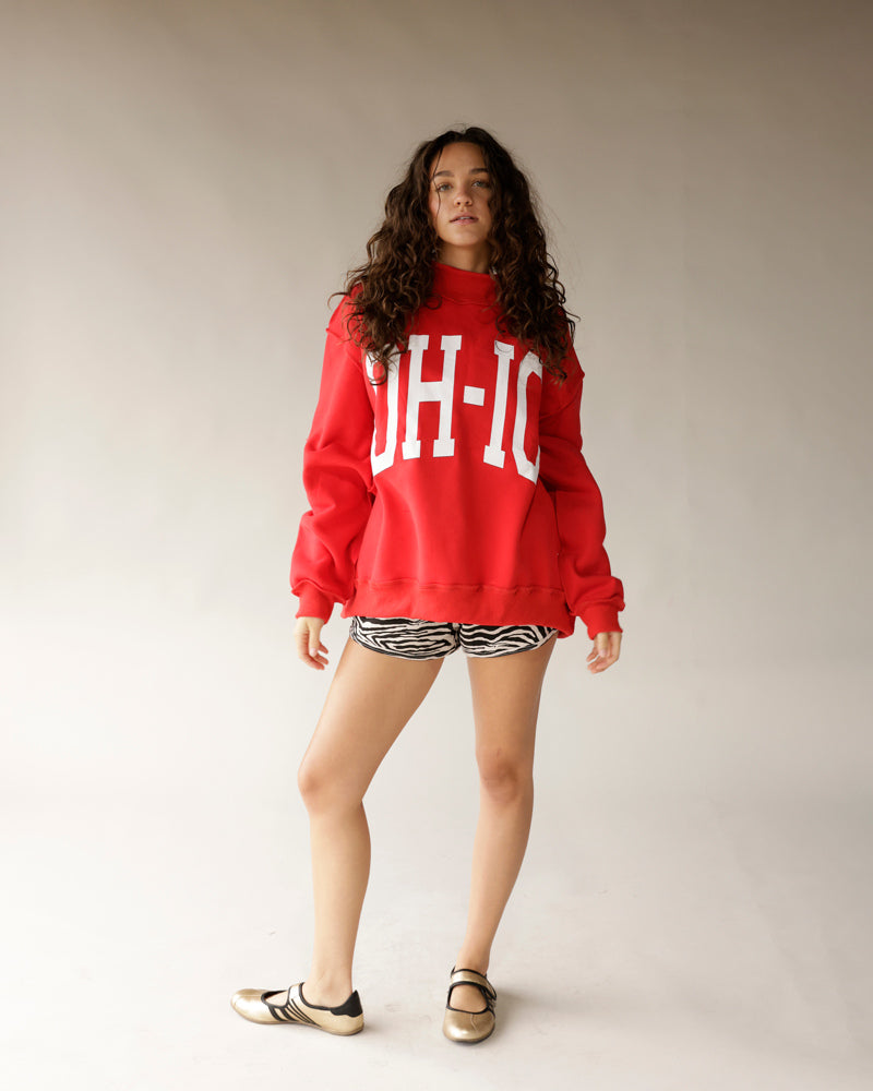 Red oversized Ohio mock neck sweatshirt with zebra print shorts and gold shoes