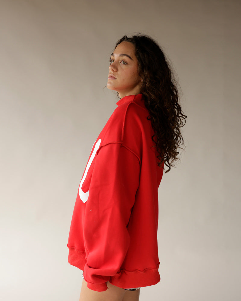 Red oversized mock neck sweatshirt with white Ohio logo, side view