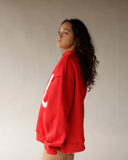 Red oversized mock neck sweatshirt with white Ohio logo, side view