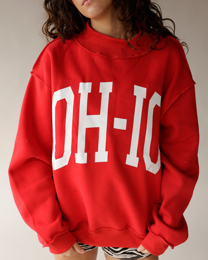 Red oversized mock neck sweatshirt with bold white OH-IO block letter print