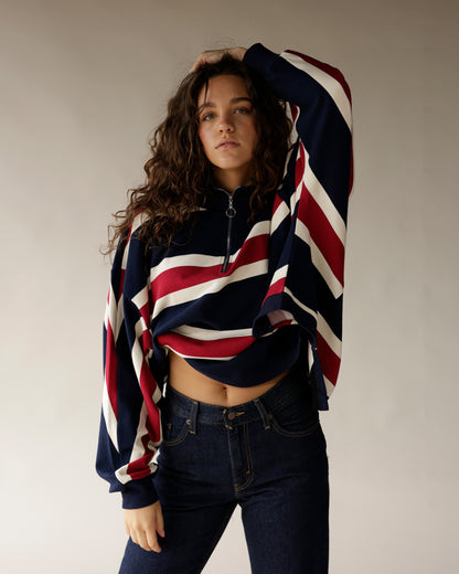 Navy, red, and white diagonal stripe quarter-zip pullover cropped sweatshirt with dark jeans