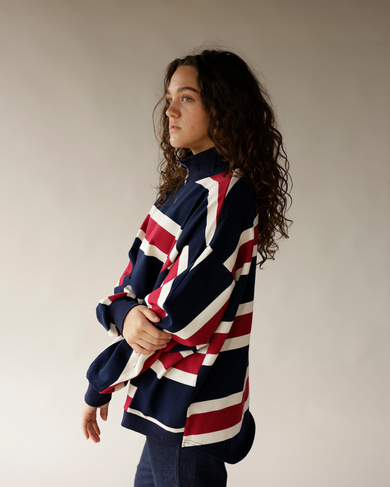 Navy, red, and white stripe quarter-zip pullover with mock neck and long sleeves.