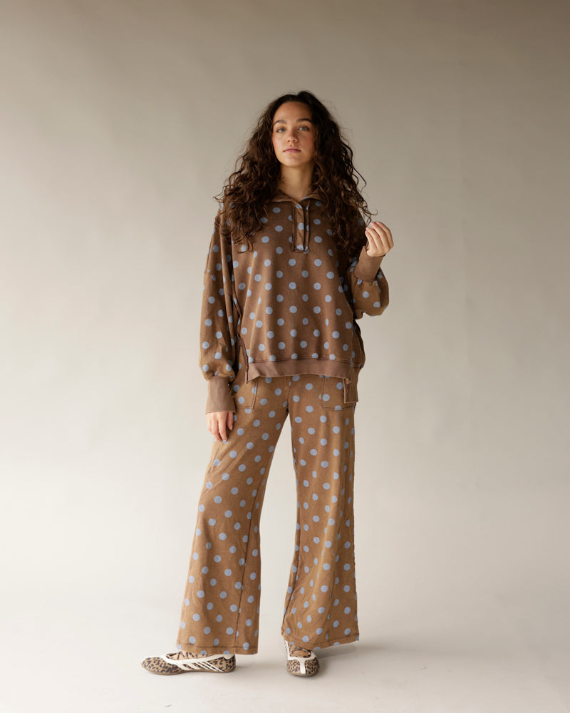 Mocha brown wide-leg lounge pants with blue polka dot pattern, flared hem