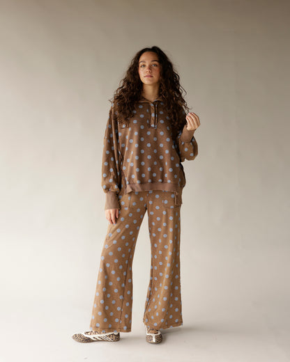 Mocha brown wide-leg lounge pants with blue polka dot pattern, flared hem