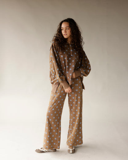 Mocha brown wide-leg lounge pants with blue polka dot pattern, relaxed fit