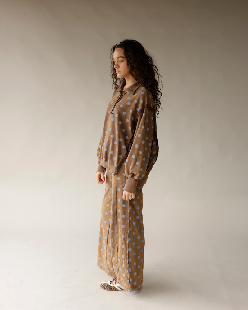 Mocha brown wide-leg lounge pants with blue polka dot pattern, worn with matching top