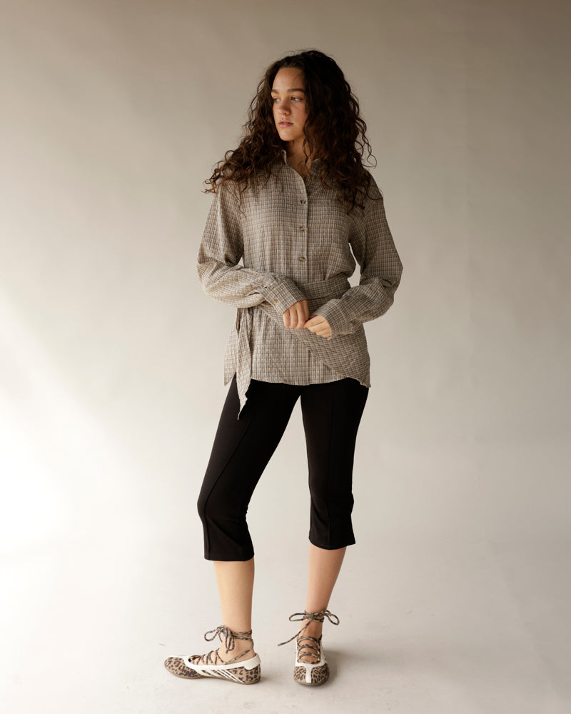 Black cropped capri pants styled with a plaid shirt and leopard print shoes