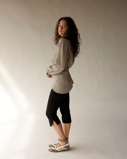Black capri pants with side slit hem, styled with plaid shirt and sneakers