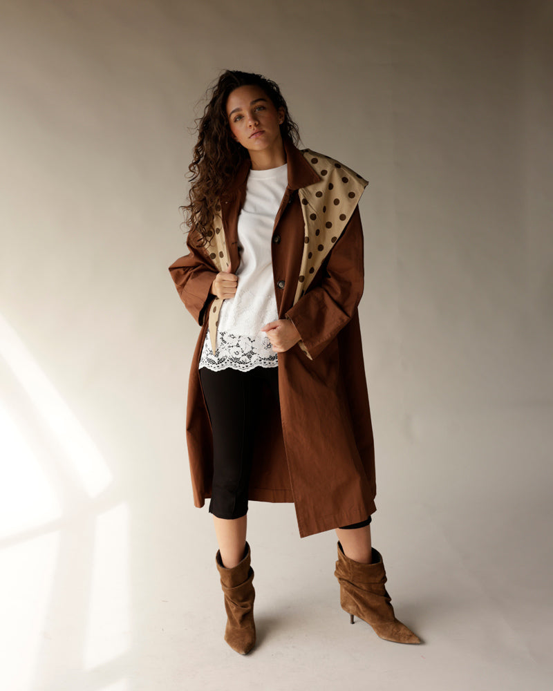 Oversized brown trench coat with detachable beige polka dot scarf collar