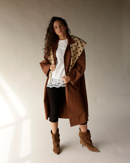 Oversized brown trench coat with detachable beige polka dot scarf collar